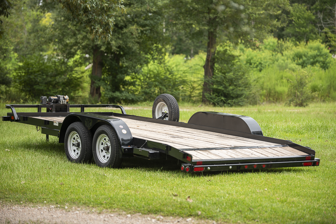 Rear view of 18ft car hauler trailer with wood deck and loading ramps