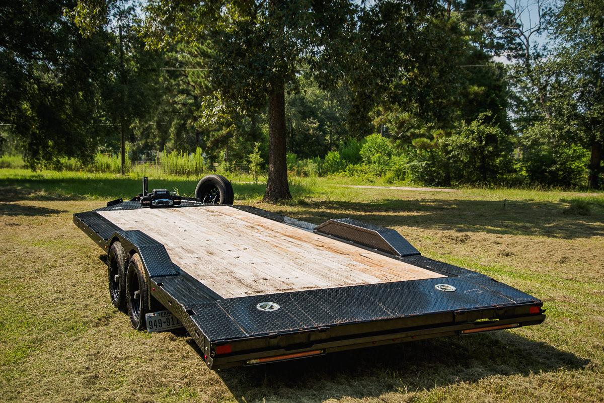 Rear view of car hauler trailer showing loading ramps and safety features